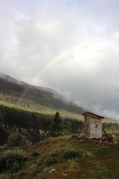 rainbow over outhouse